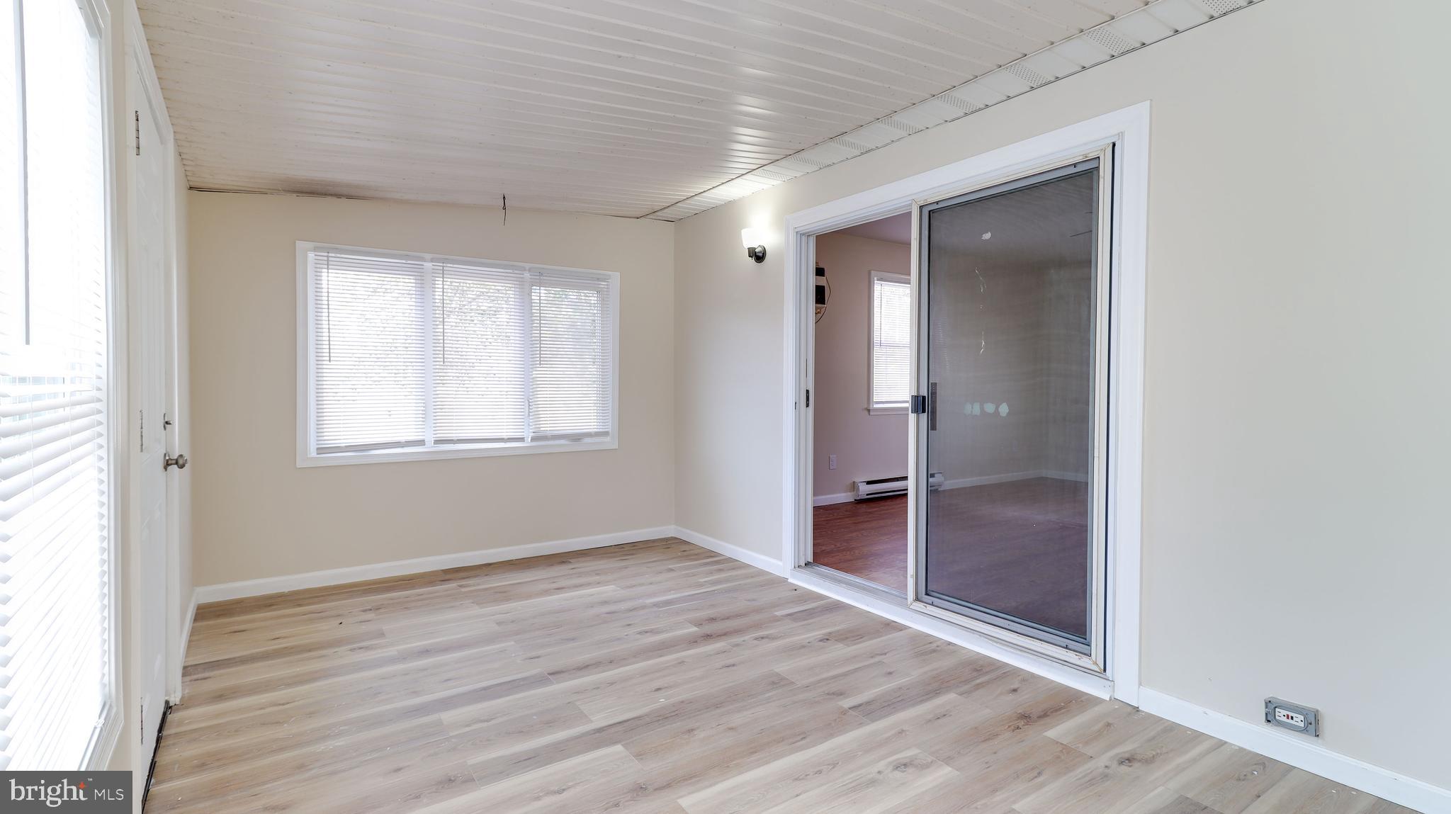 519 Back Neck Road Bridgeton, NJ 08302 - Photo 5 of 12 an empty room with wooden floor and a window