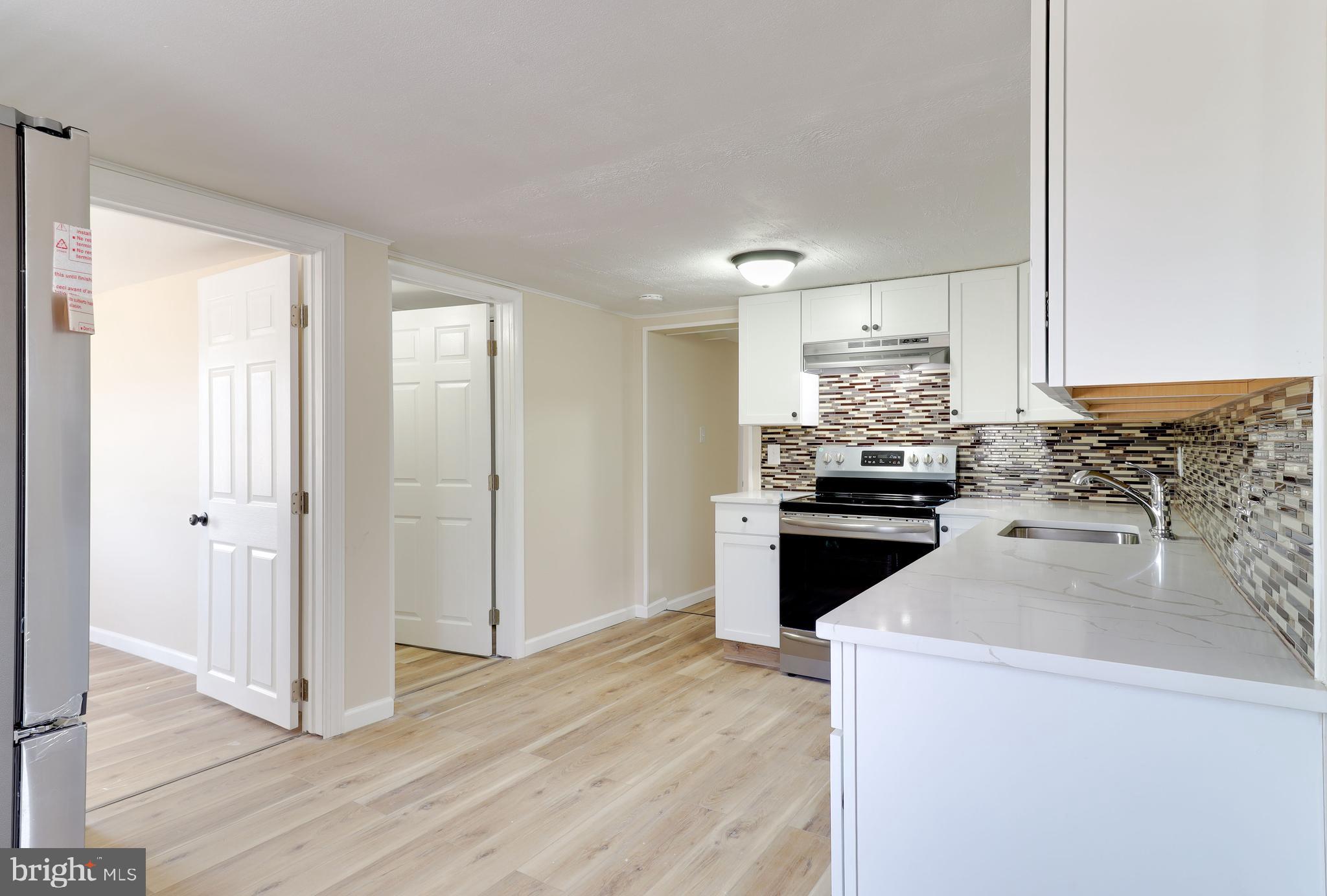 519 Back Neck Road Bridgeton, NJ 08302 - Photo 7 of 12 a kitchen with granite countertop a sink and a stove top oven