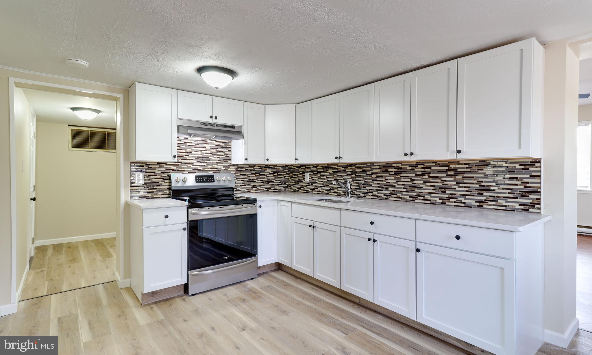 519 Back Neck Road Bridgeton, NJ 08302 - Photo 8 of 12 a kitchen with granite countertop white cabinets and white appliances