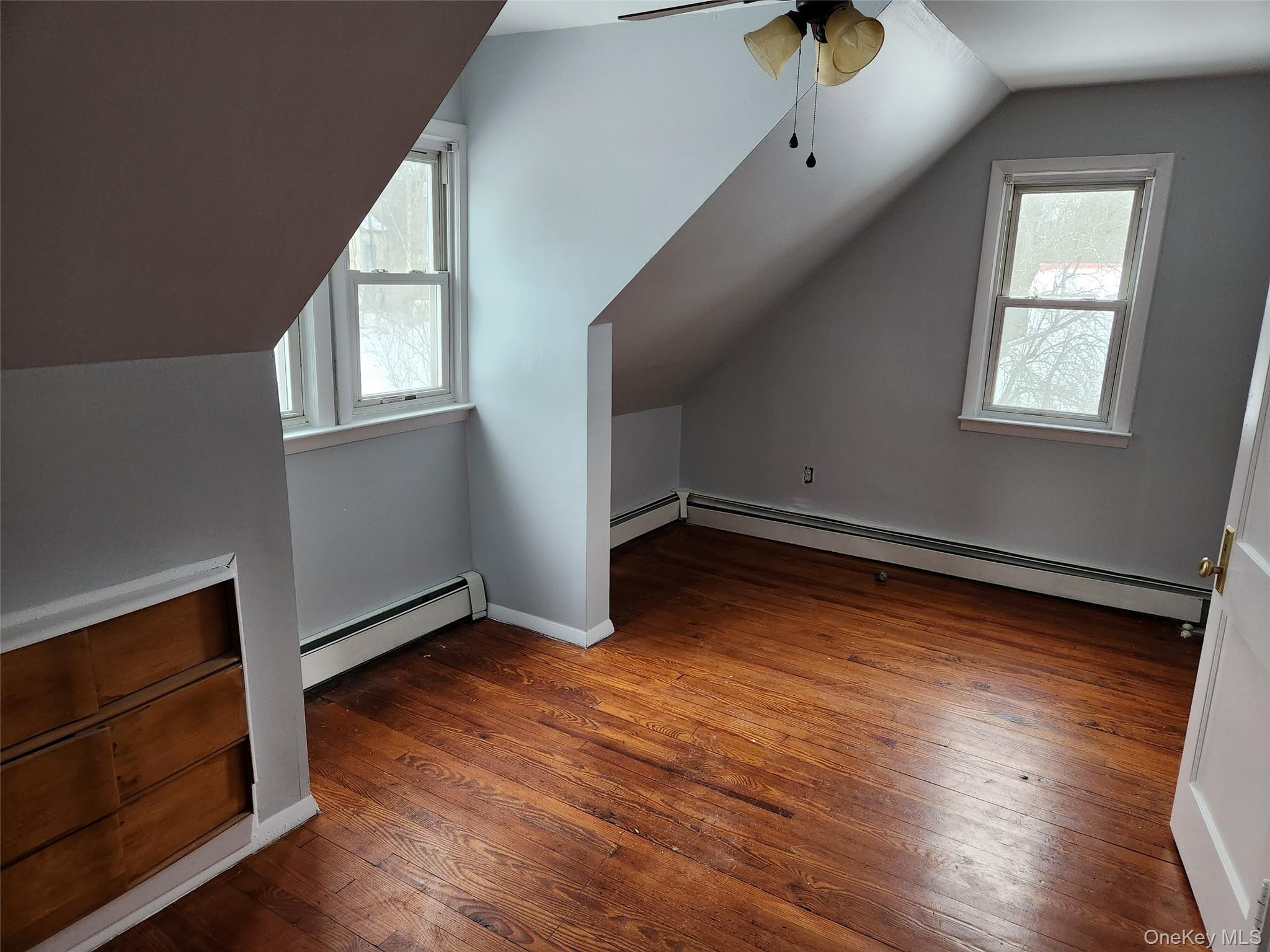 72 Stanton Corner Road, Unit 2 Swan Lake, NY 12783 - Photo 6 of 7 an empty room with wooden floor and windows
