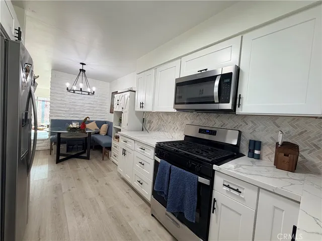 a kitchen with a sink and a stove top oven