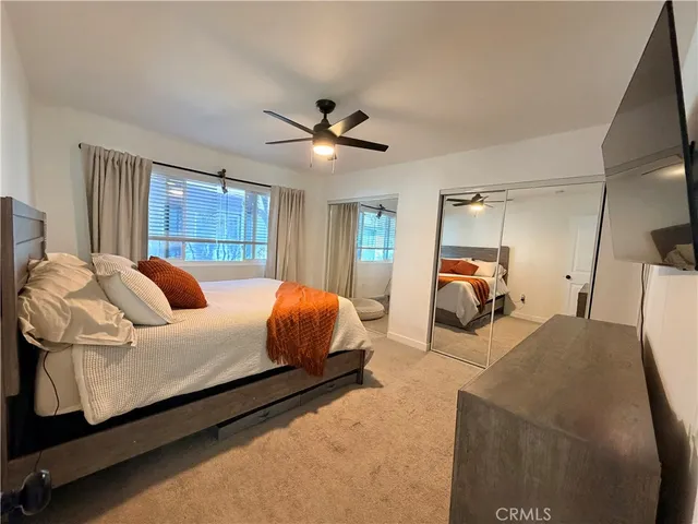 a bed room with a bed and a large mirror