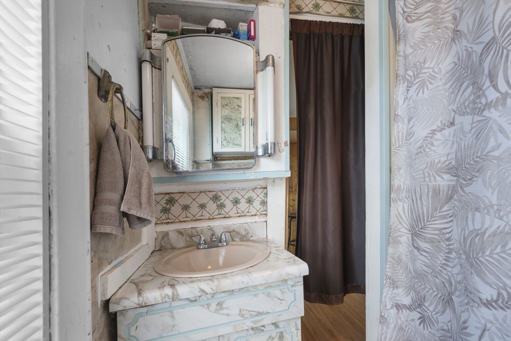 17-19 Whitehall Road Amesbury, MA 01913 - Photo 20 of 37 a bathroom with a sink and a mirror