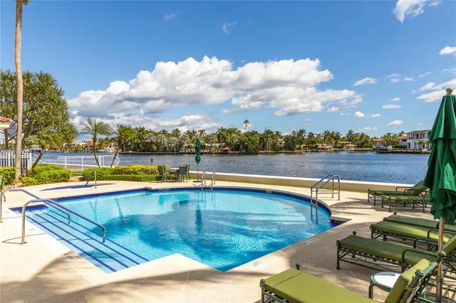 a view of a swimming pool with an outdoor seating and a yard
