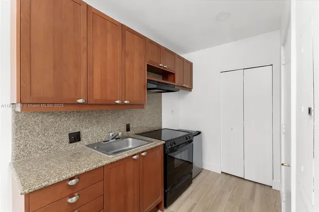 a kitchen with stainless steel appliances granite countertop a sink stove and microwave