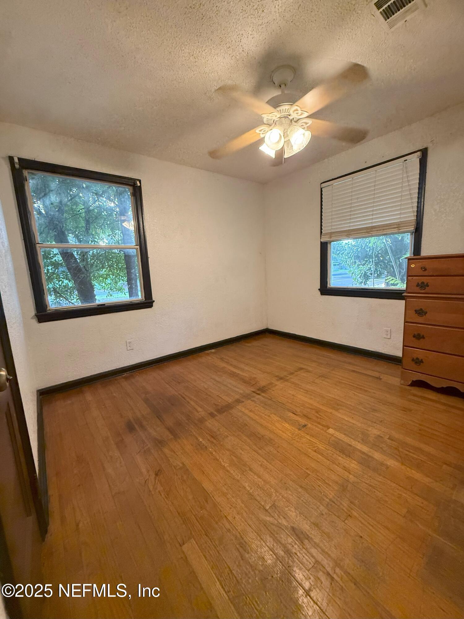 3546 Oleander Street Jacksonville, FL 32254 - Photo 15 of 32 a view of an empty room with a window and wooden floor
