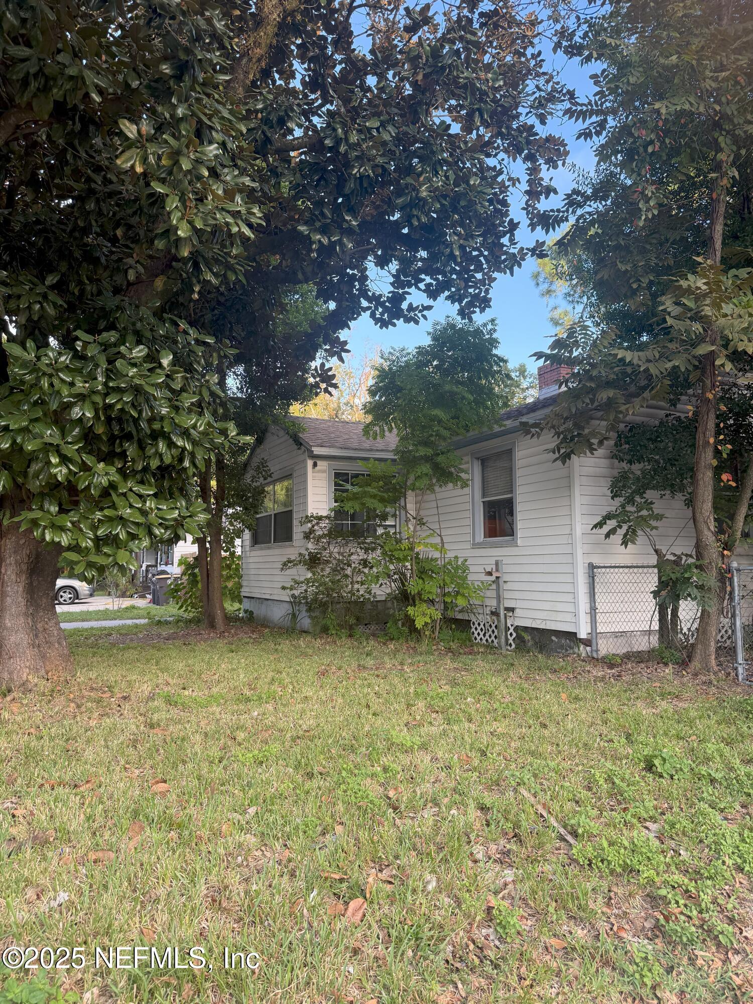 3546 Oleander Street Jacksonville, FL 32254 - Photo 30 of 32 a view of a house with backyard and tree