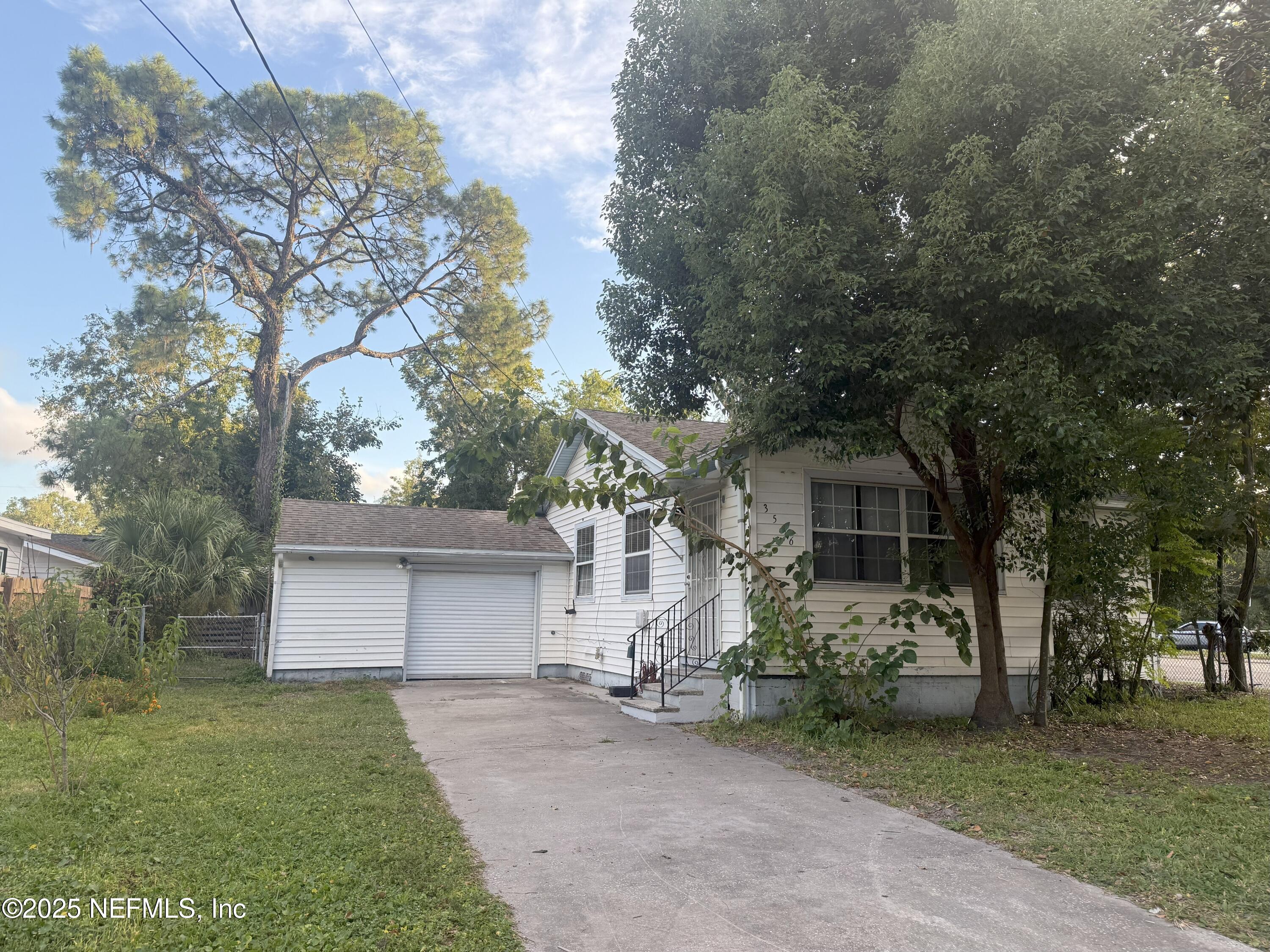 3546 Oleander Street Jacksonville, FL 32254 - Photo 32 of 32 a view of a house with a large tree and a yard