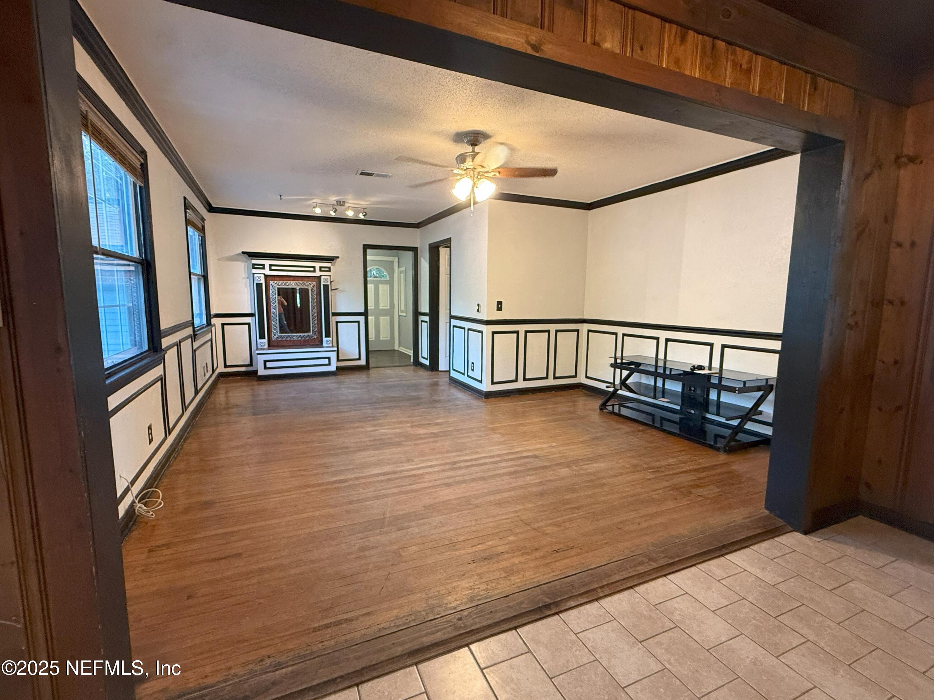 3546 Oleander Street Jacksonville, FL 32254 - Photo 8 of 32 a view of a hallway with wooden floor and staircase