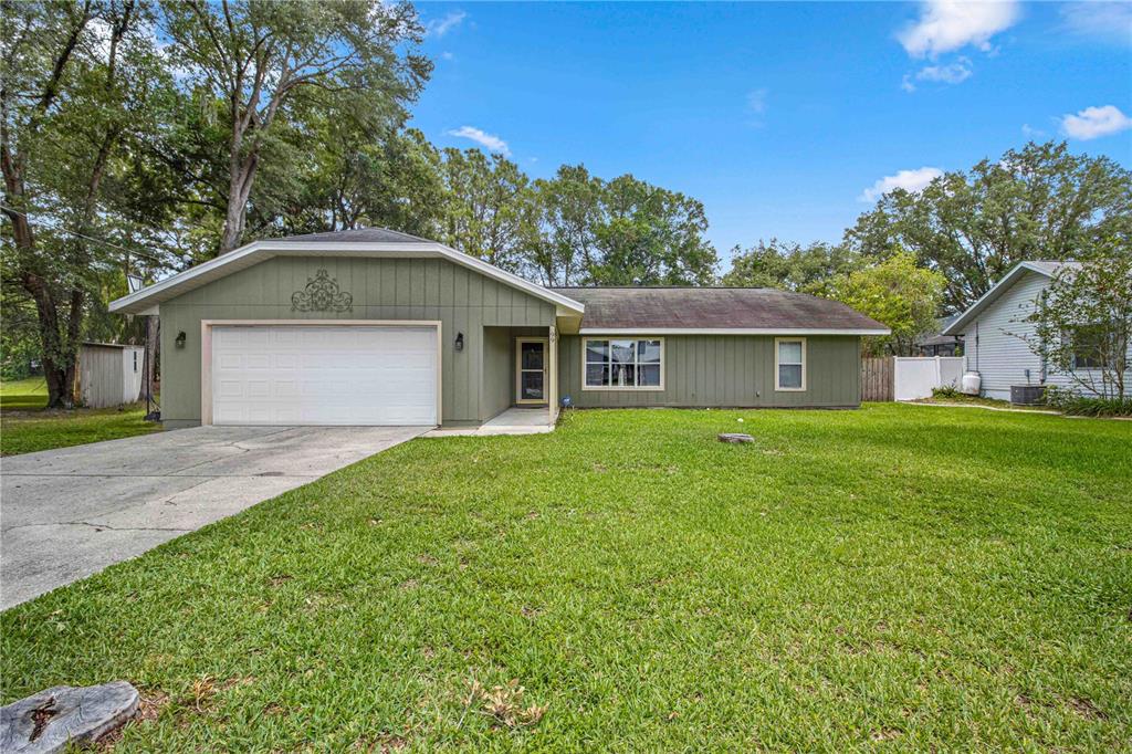 99 Teak Loop Ocala, FL 34472 - Photo 1 of 1 a front view of house with yard and green space