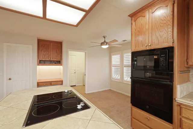 a room with a table and a ceiling fan