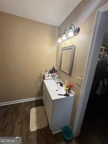 a bathroom with a sink vanity and mirror