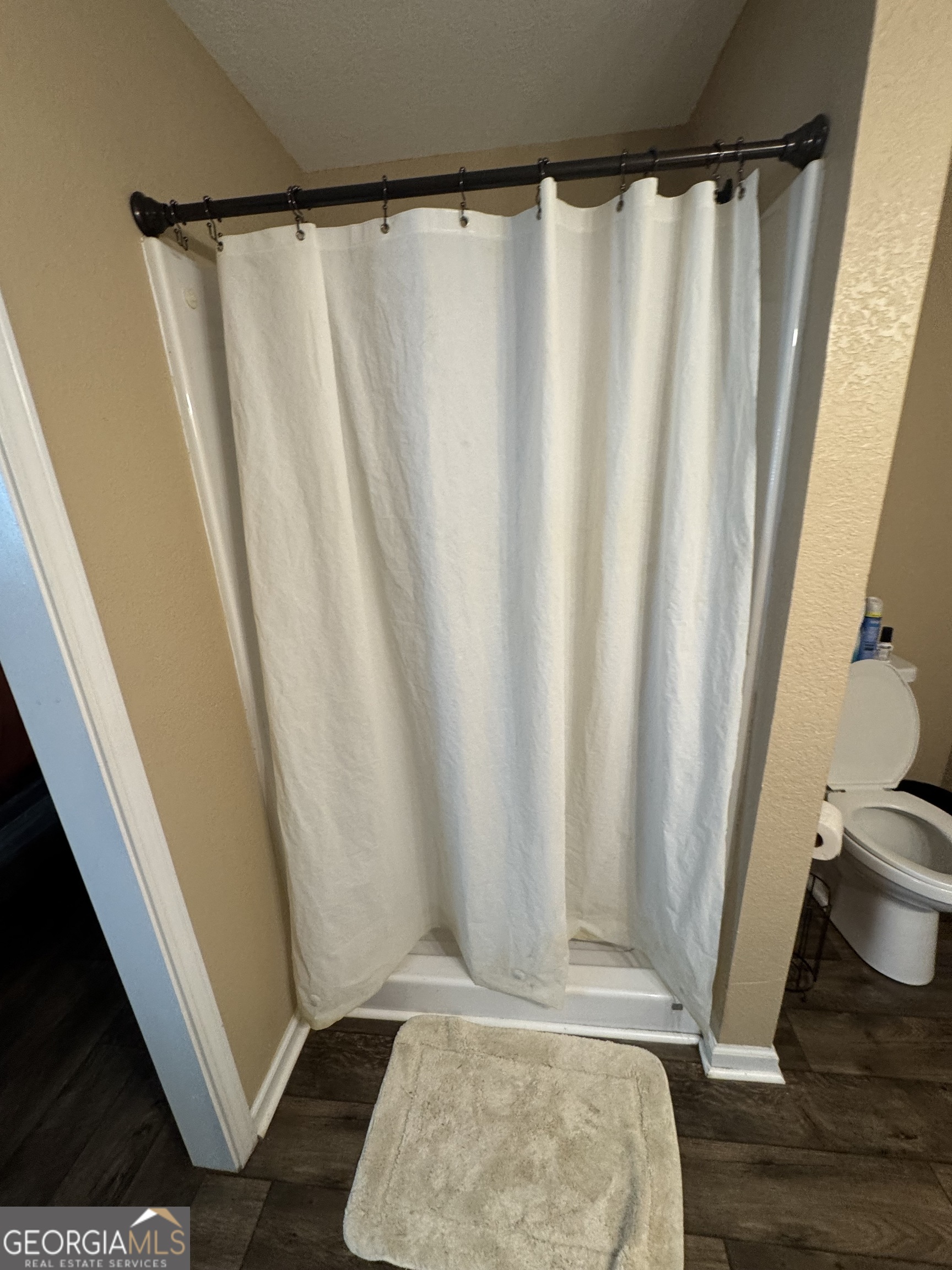 353 Mosley Road Vidalia, GA 30474 - Photo 14 of 14 a view of walk in closet with wooden floor and shower