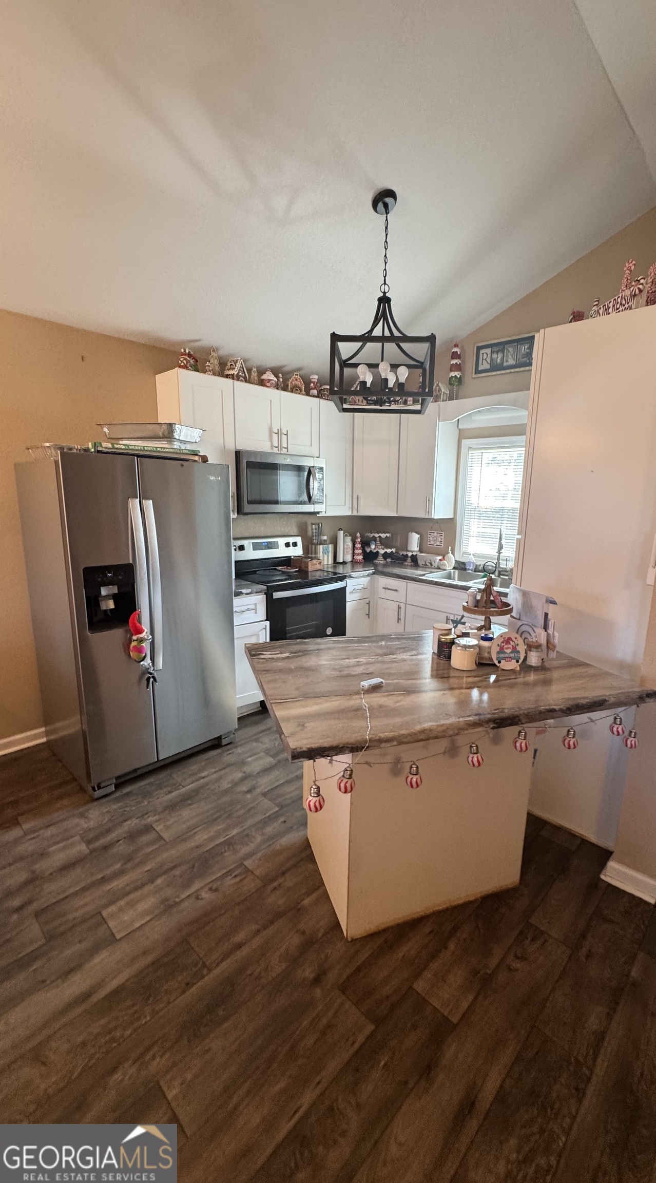 353 Mosley Road Vidalia, GA 30474 - Photo 8 of 14 a view of a kitchen with kitchen island stainless steel appliances a sink and wooden floor