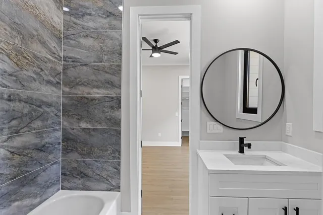 a bathroom with a sink a toilet and a mirror