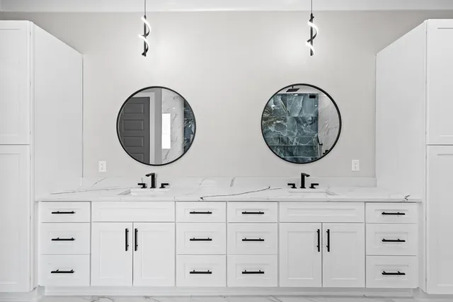 a kitchen with white cabinets and refrigerator