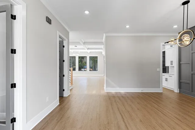 a view of a hallway with wooden floor