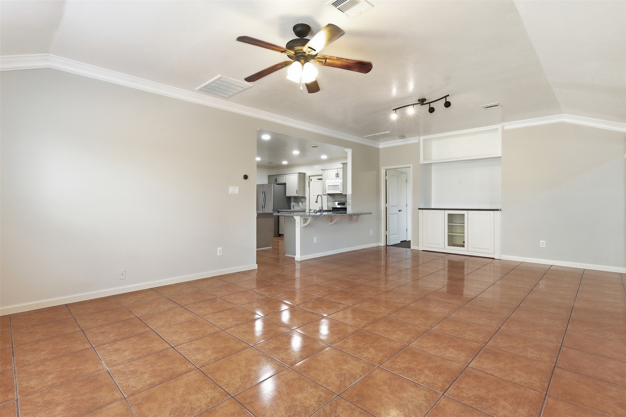 12638 Coho Lane Houston, TX 77045 - Photo 13 of 29 a view of a livingroom with a ceiling fan and kitchen view