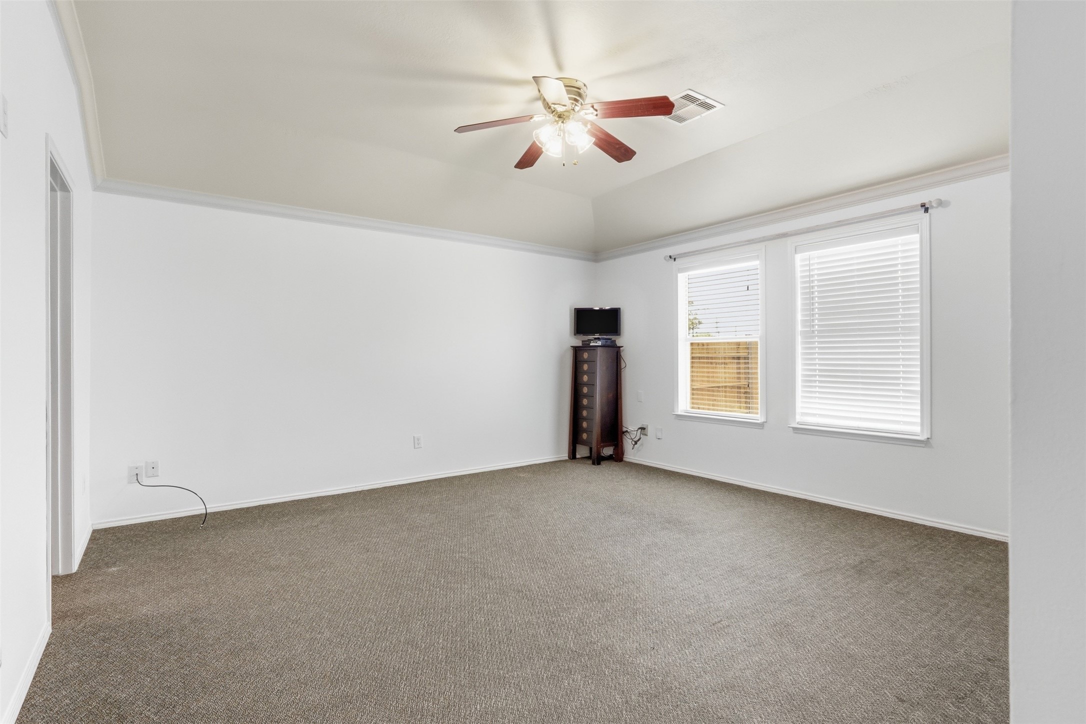 12638 Coho Lane Houston, TX 77045 - Photo 17 of 29 an empty room with chandelier fan and windows