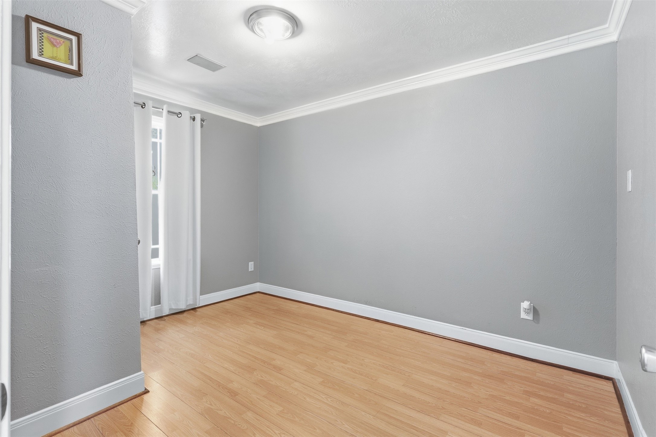 12638 Coho Lane Houston, TX 77045 - Photo 3 of 29 an empty room with wooden floor and windows