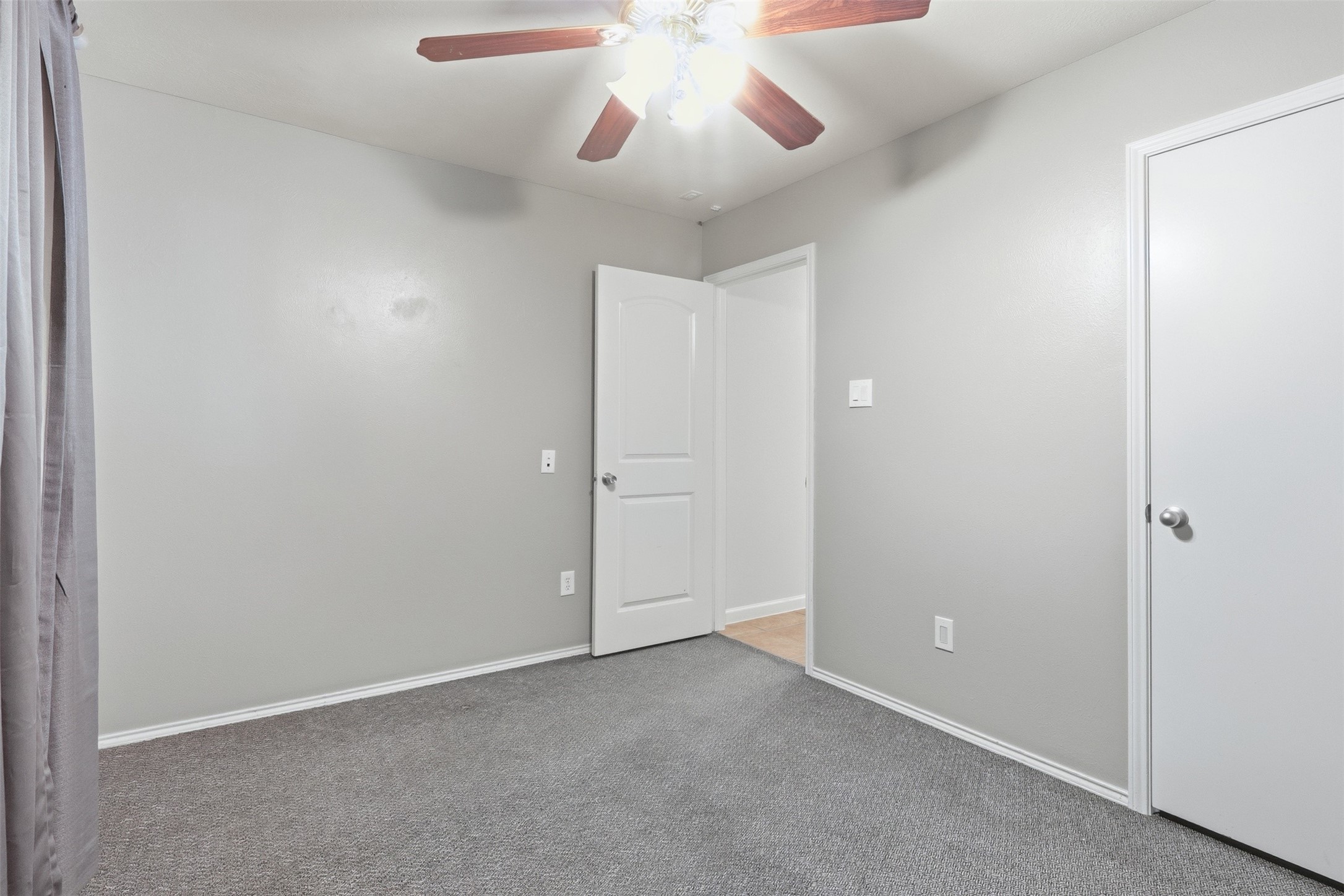 12638 Coho Lane Houston, TX 77045 - Photo 6 of 29 an empty room with chandelier fan