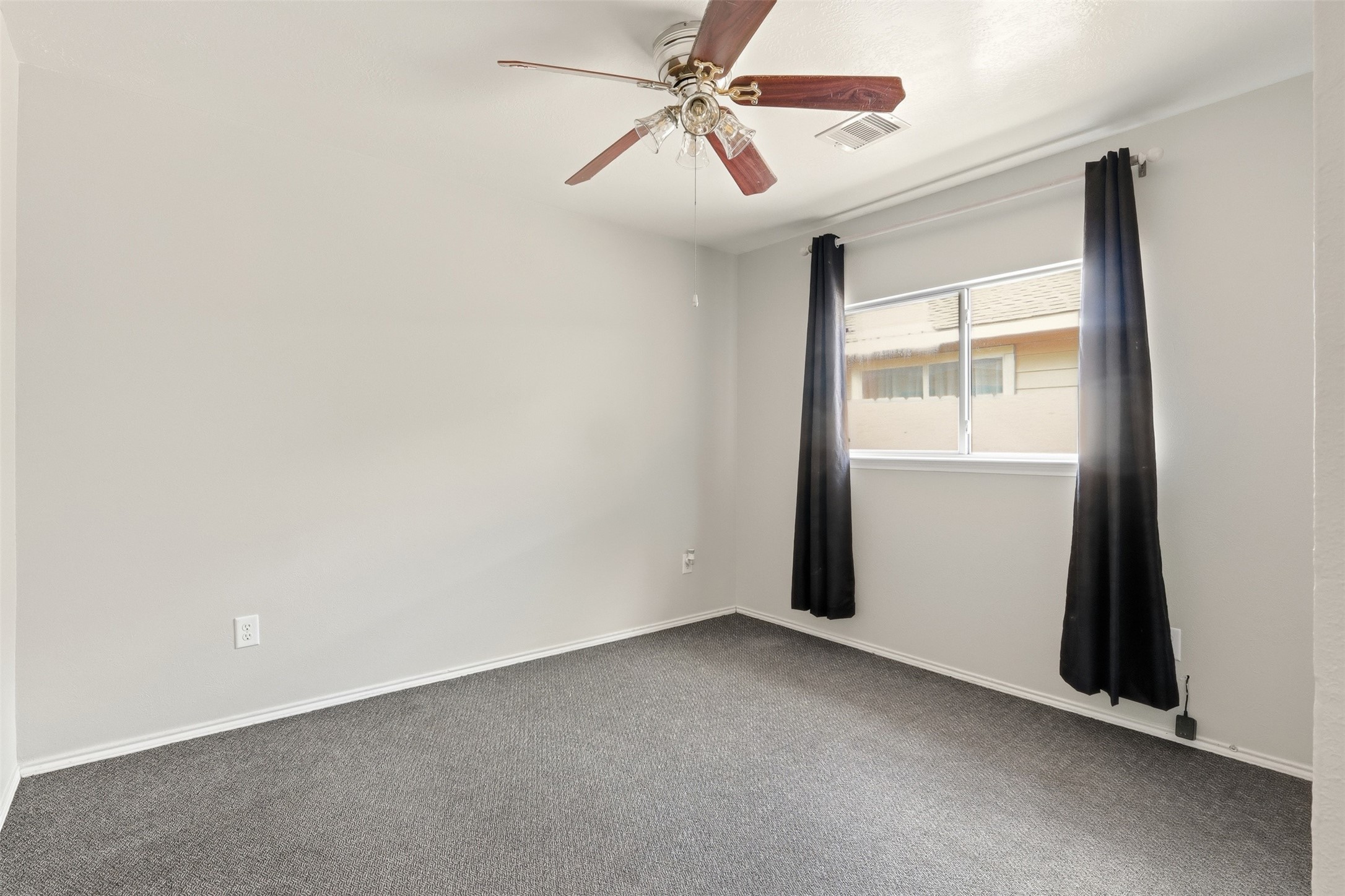 12638 Coho Lane Houston, TX 77045 - Photo 8 of 29 an empty room with a window and a fan
