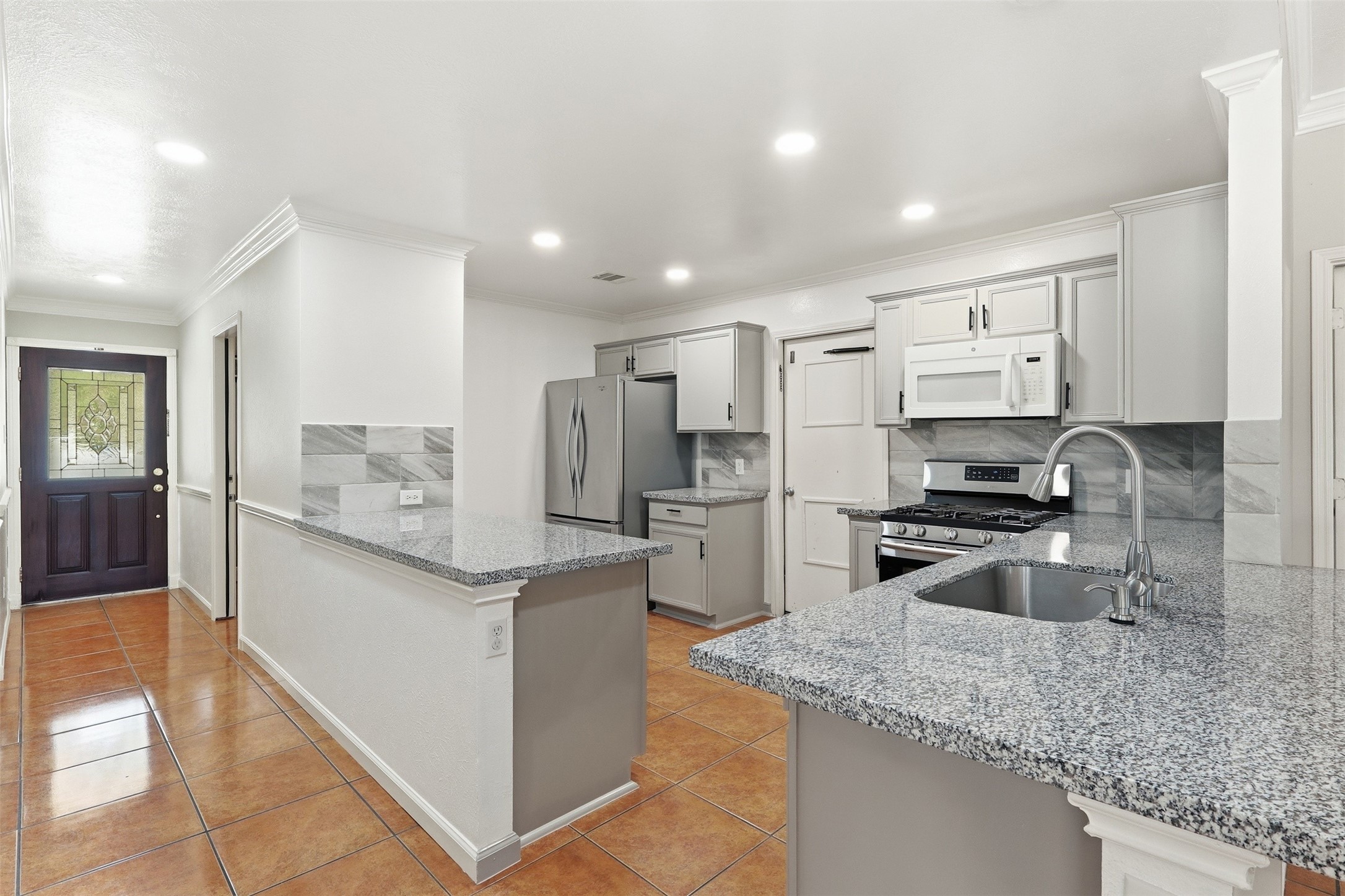 12638 Coho Lane Houston, TX 77045 - Photo 10 of 29 a kitchen with stainless steel appliances granite countertop a sink stove and refrigerator