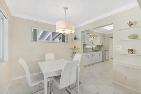 a living room with furniture a chandelier and a flat screen tv
