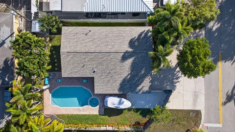 a aerial view of a house with a yard and potted plants