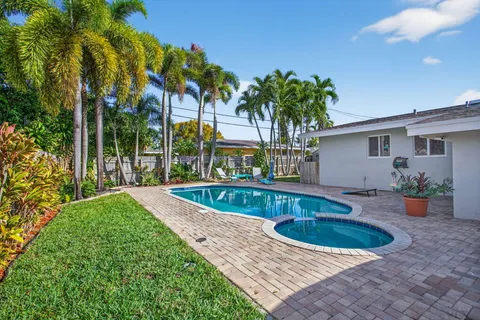 a view of swimming pool with outdoor seating and plants