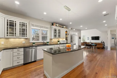 a kitchen with stainless steel appliances granite countertop a stove and a sink