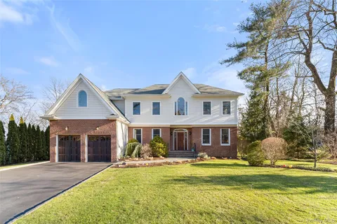 a front view of a house with swimming pool and porch with furniture