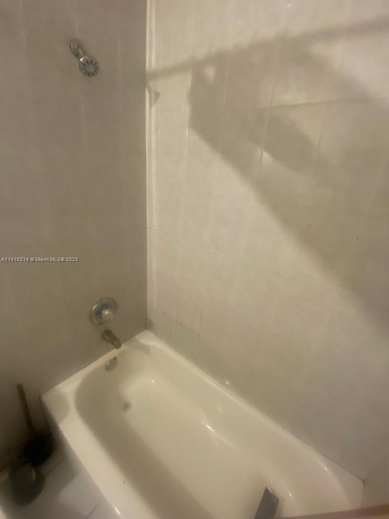 6032 Southwest 38th Street, Unit 1 Miramar, FL 33023 - Photo 6 of 6 a bathroom with a white bath tub and a white shower