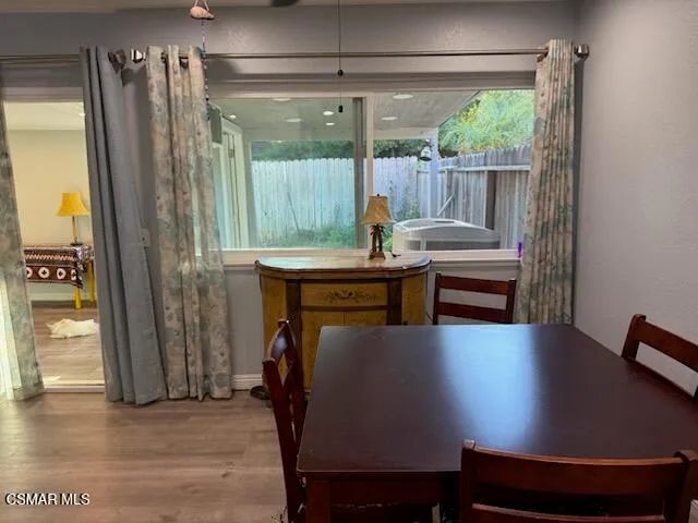 a view of a livingroom with furniture and a window