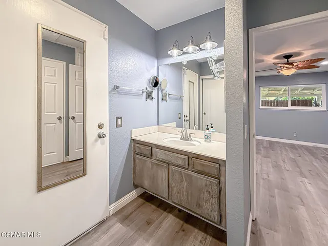 a bathroom with a double vanity sink and a mirror