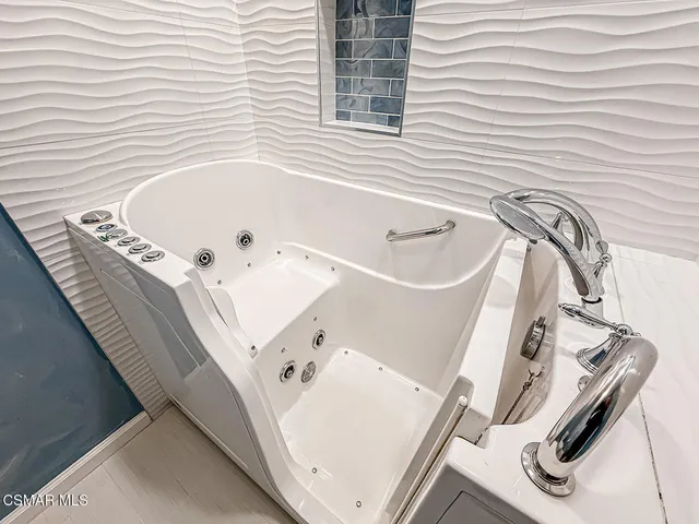 a bathroom with a bathtub and a sink