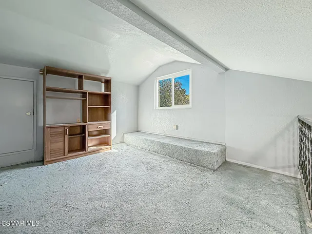 a living room with chairs and a wooden floor
