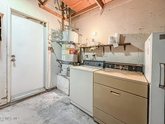 a view of a house with a tree and wooden fence
