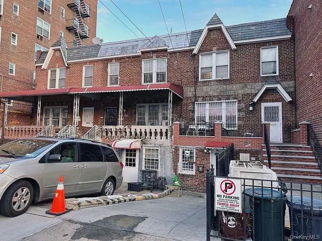 a front view of a house with parking space