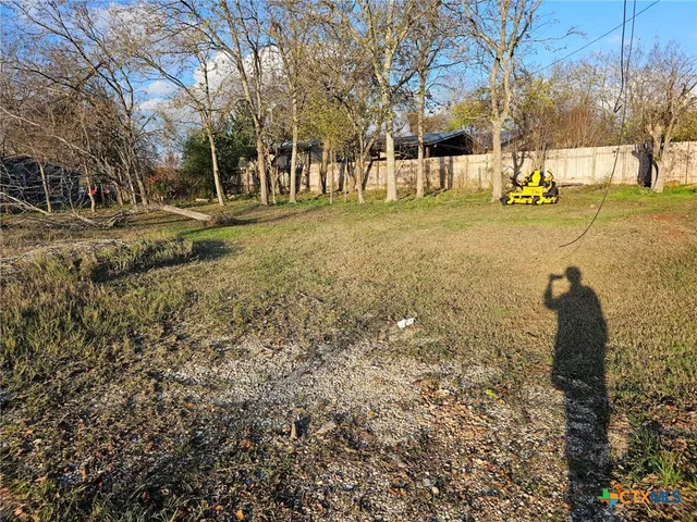 a backyard of apartments with large trees