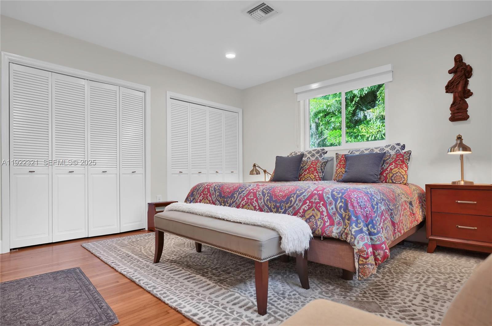 1409 Bird Road Coral Gables, FL 33146 - Photo 11 of 36 a spacious bedroom with a bed and a window