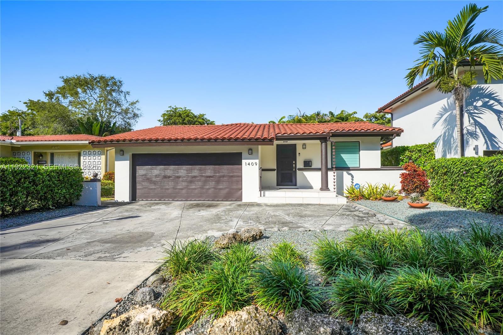 1409 Bird Road Coral Gables, FL 33146 - Photo 27 of 36 front view of a house with a yard