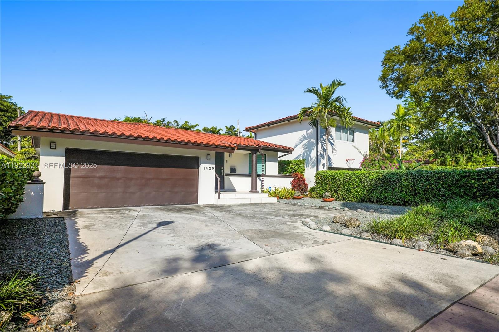 1409 Bird Road Coral Gables, FL 33146 - Photo 28 of 36 a view of a house with a yard and garage