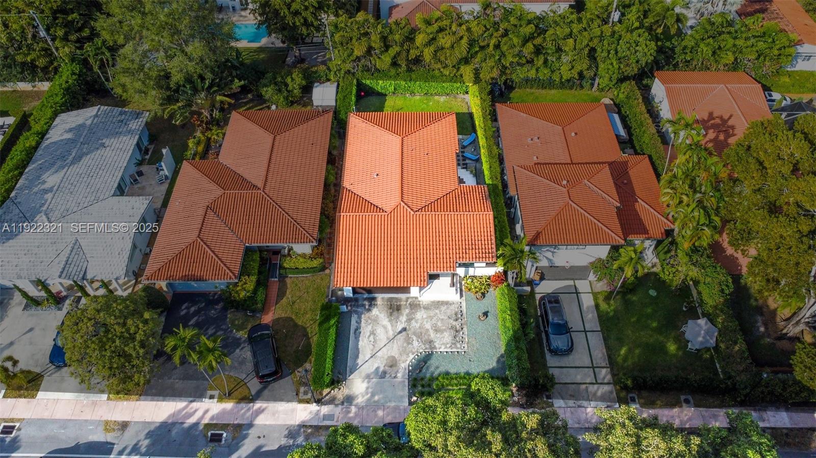 1409 Bird Road Coral Gables, FL 33146 - Photo 33 of 36 an aerial view of a house with outdoor space and a parking space