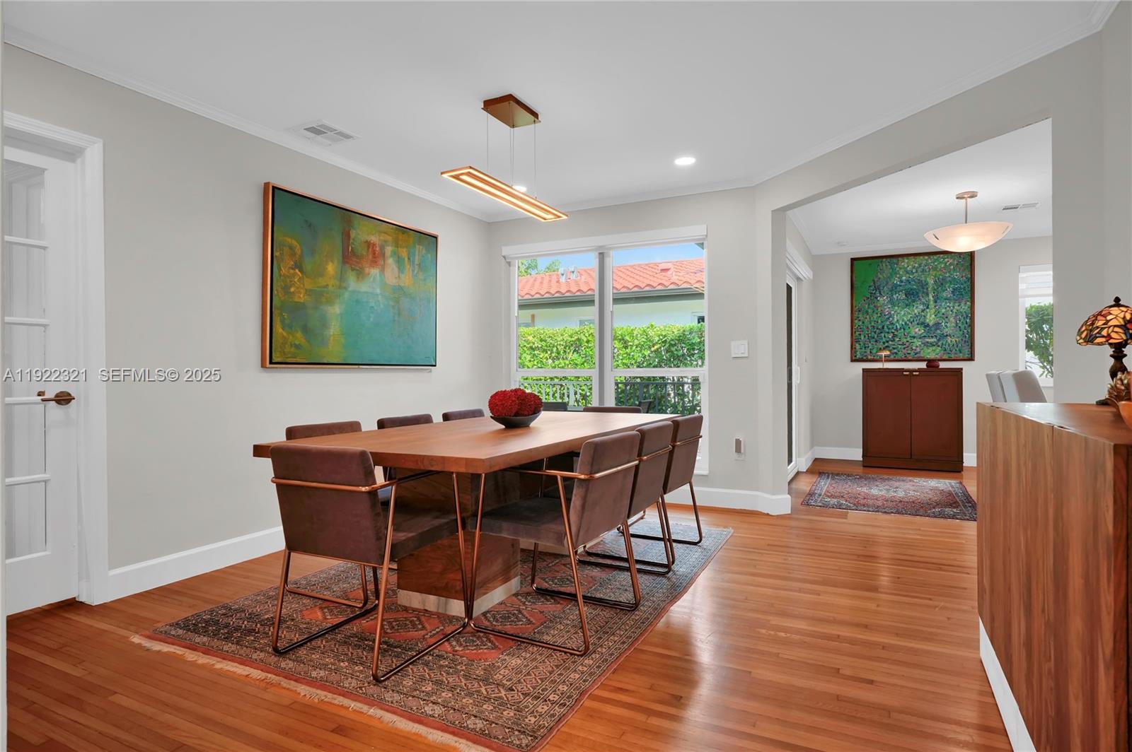 1409 Bird Road Coral Gables, FL 33146 - Photo 6 of 36 a view of a dining room with furniture window and wooden floor