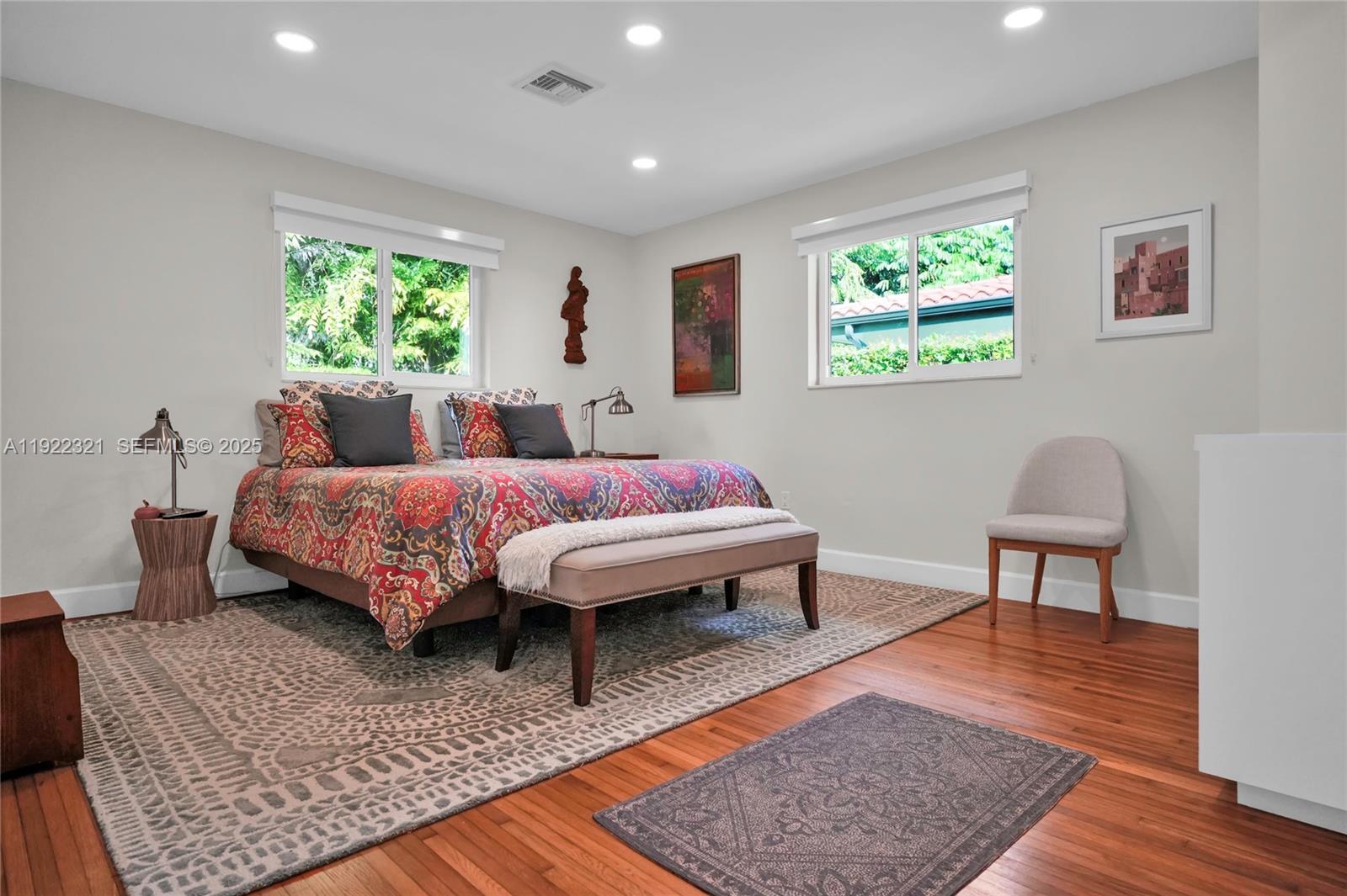 1409 Bird Road Coral Gables, FL 33146 - Photo 9 of 36 a bedroom with a bed wooden floor and a window