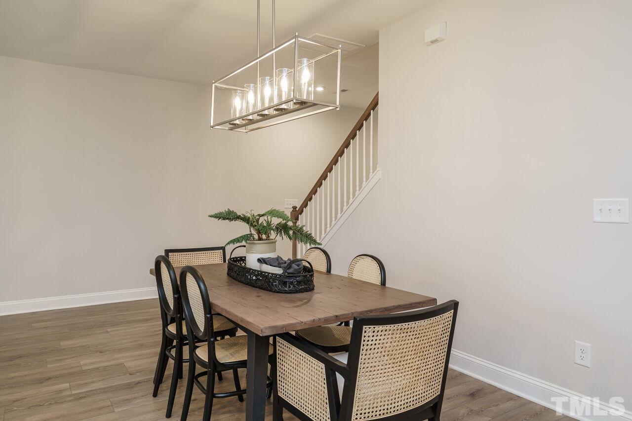 3111 Dunnock Drive, Unit 4 Durham, NC 27713 - Photo 7 of 26 a view of a dining room with furniture and wooden floor