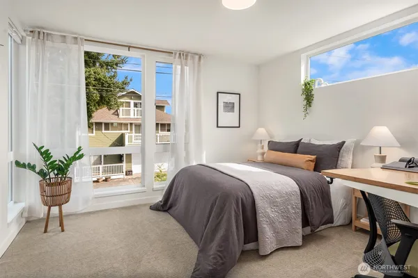 a bedroom with a bed and a potted plant