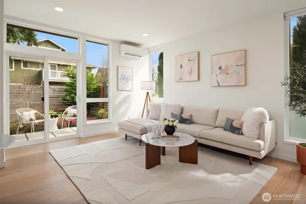 a living room with furniture and a floor to ceiling window