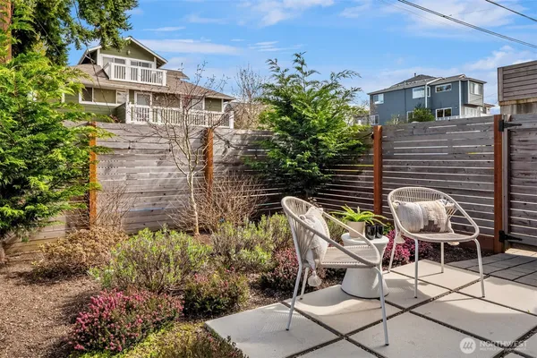 a view of a patio with table and chairs and potted plants